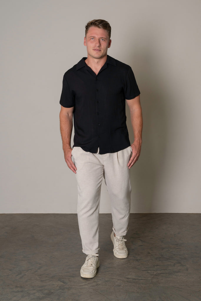 "Black Cuban Short Sleeve Shirt for men with white geometric print, button-up front, Cuban collar, short sleeves, and curved hem. Smart casual summer shirt, lightweight and breathable fabric."