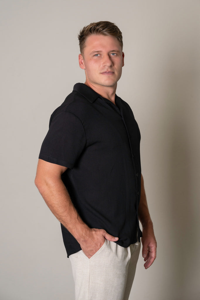 "Black Cuban Short Sleeve Shirt for men with white geometric print, button-up front, Cuban collar, short sleeves, and curved hem. Smart casual summer shirt, lightweight and breathable fabric."