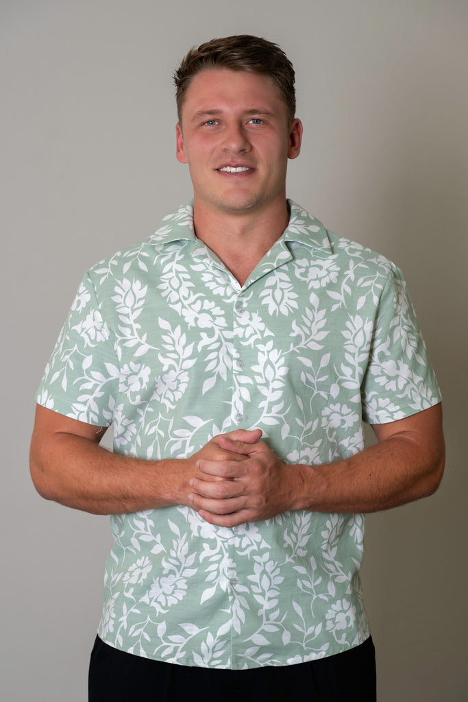Close-up of the Men’s Cuban Short Sleeve Shirt in Sage, highlighting the crisp Cuban collar, button details, and premium lightweight fabric with an Leafwhite pattern.