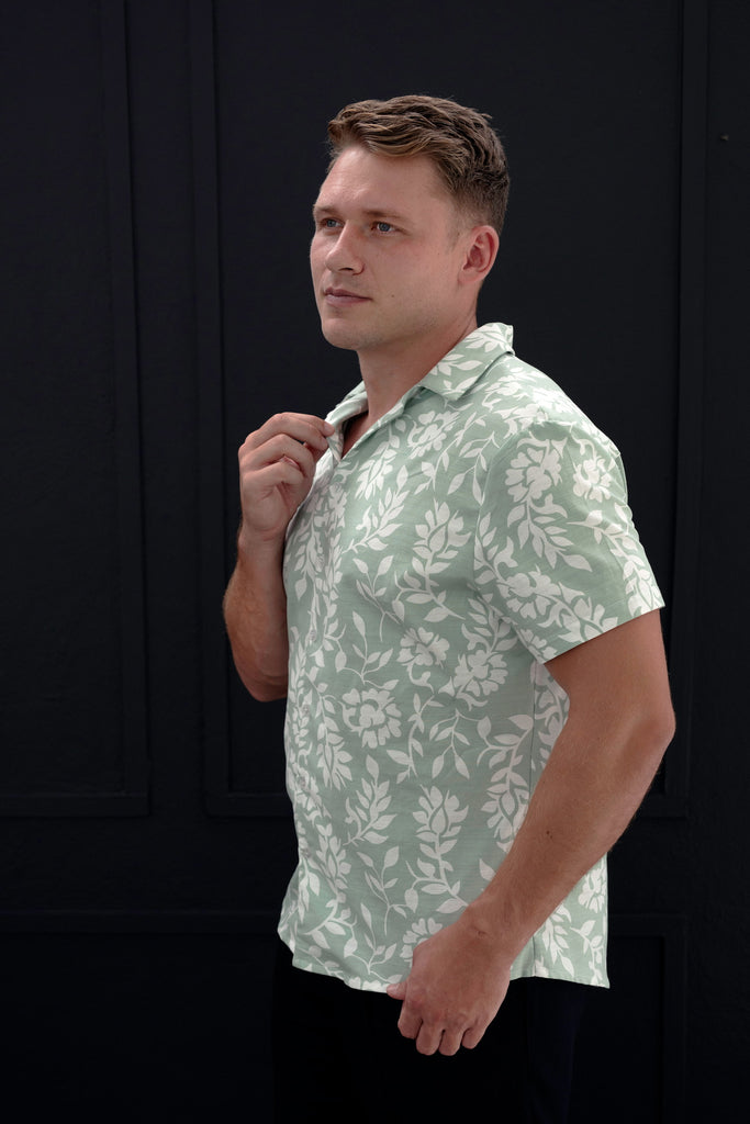 "Sage Men’s Cuban Short Sleeve Shirt with a white Leaf pattern, showcasing Cuban collar, button-up front, short sleeves, and curved hem. High-quality fabric with a structured yet relaxed fit."