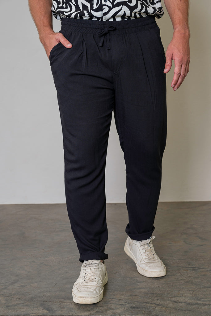 Front View (Worn by Model, Standing Straight)
"Men’s Lightweight Tailored Drawstring Trousers in black, featuring a relaxed yet structured fit with pleats, an elastic waistband, and an adjustable drawstring. Smart-casual trousers for versatile styling."
