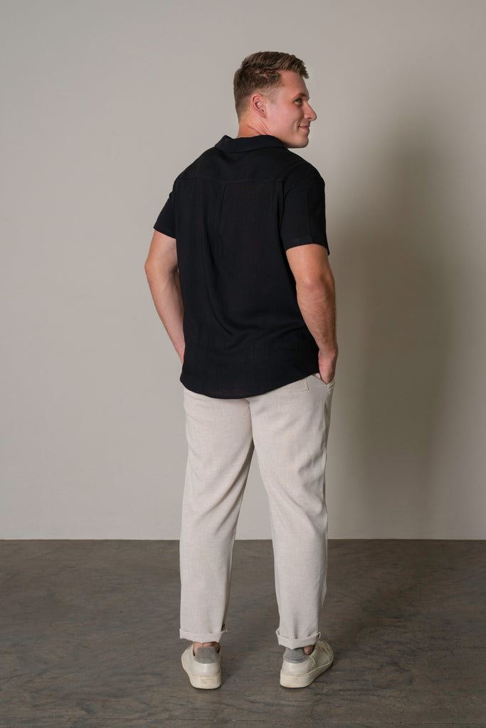 Full-Body Back Shot
"Full-body back shot of a man wearing lightweight tailored drawstring trousers in sand beige, offering a stylish and contemporary look. The slim-fit trousers are paired with a casual or smart top, perfect for warm weather or layering in any season."
